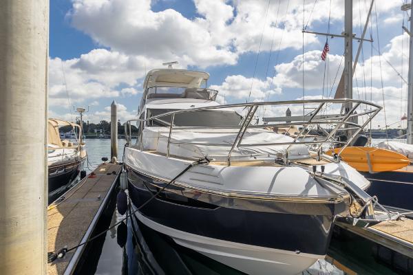 Slide: The Image of Azimut 60 Flybridge 2021 yacht docked under a bright blue sky. - 4