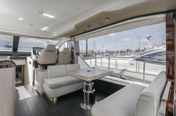 Slide: The Image of Luxurious interior of 2021 Azimut 60 Flybridge yacht with elegant seating and marina view. - 42