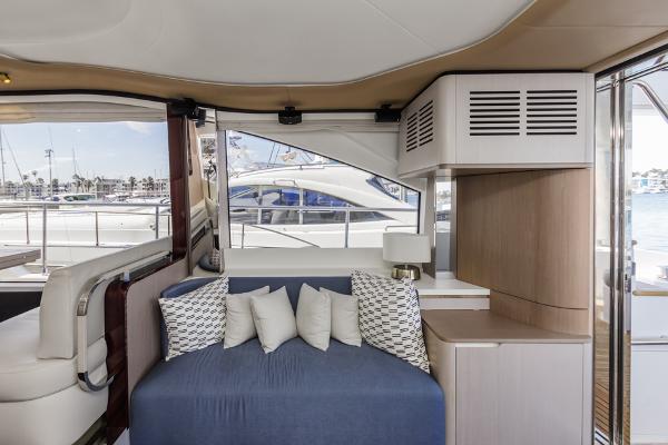 Slide: The Image of Interior of 2021 Azimut 60 Flybridge yacht with modern seating and window view. - 44