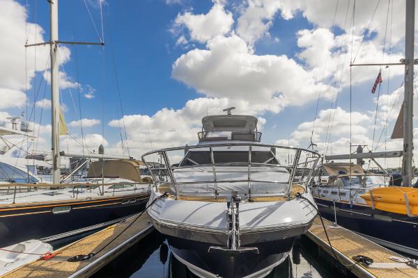 Slide: The Image of Azimut 60 Flybridge 2021 yacht docked under a bright blue sky with clouds. - 5