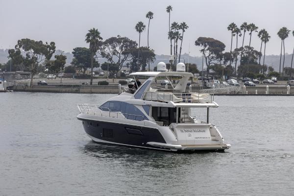 Slide: The Image of Azimut 60 Flybridge 2021 yacht cruising near a scenic shoreline with palm trees. - 8
