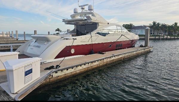 Slide: The Image of 2009 Azimut 68S luxury yacht docked at a marina. - 4