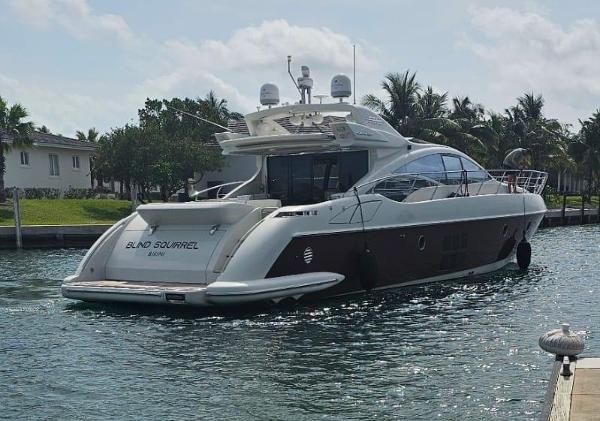 Slide: The Image of 2009 Azimut 68S yacht named Blind Squirrel docked in a tropical marina. - 5