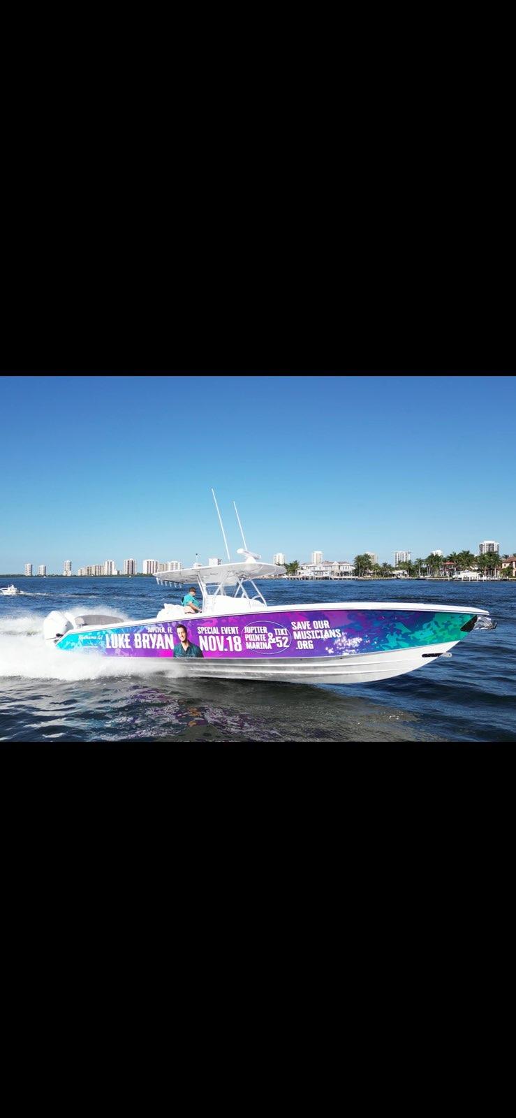 Slide: The Image of 2024 Bahama 41' Open Fisherman boat with promotional wrap for a special event. - 2