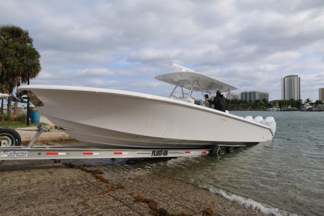 Slide: The Image of 2024 Bahama 41' Open Fisherman boat being launched from a trailer into the water. - 4