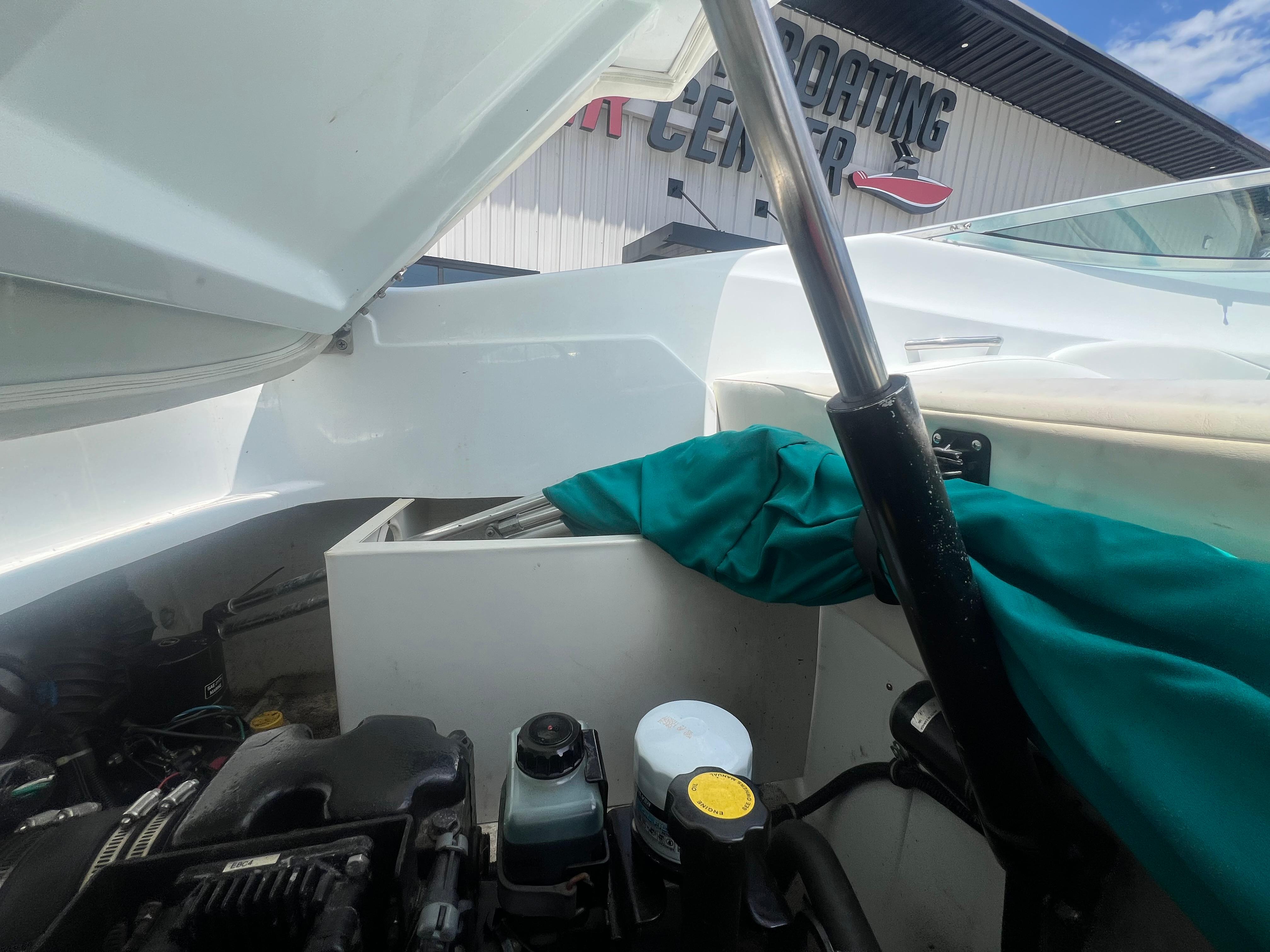 Slide: The Image of Open engine compartment of a 1999 Baja 272 Islander boat at a boating center. - 15