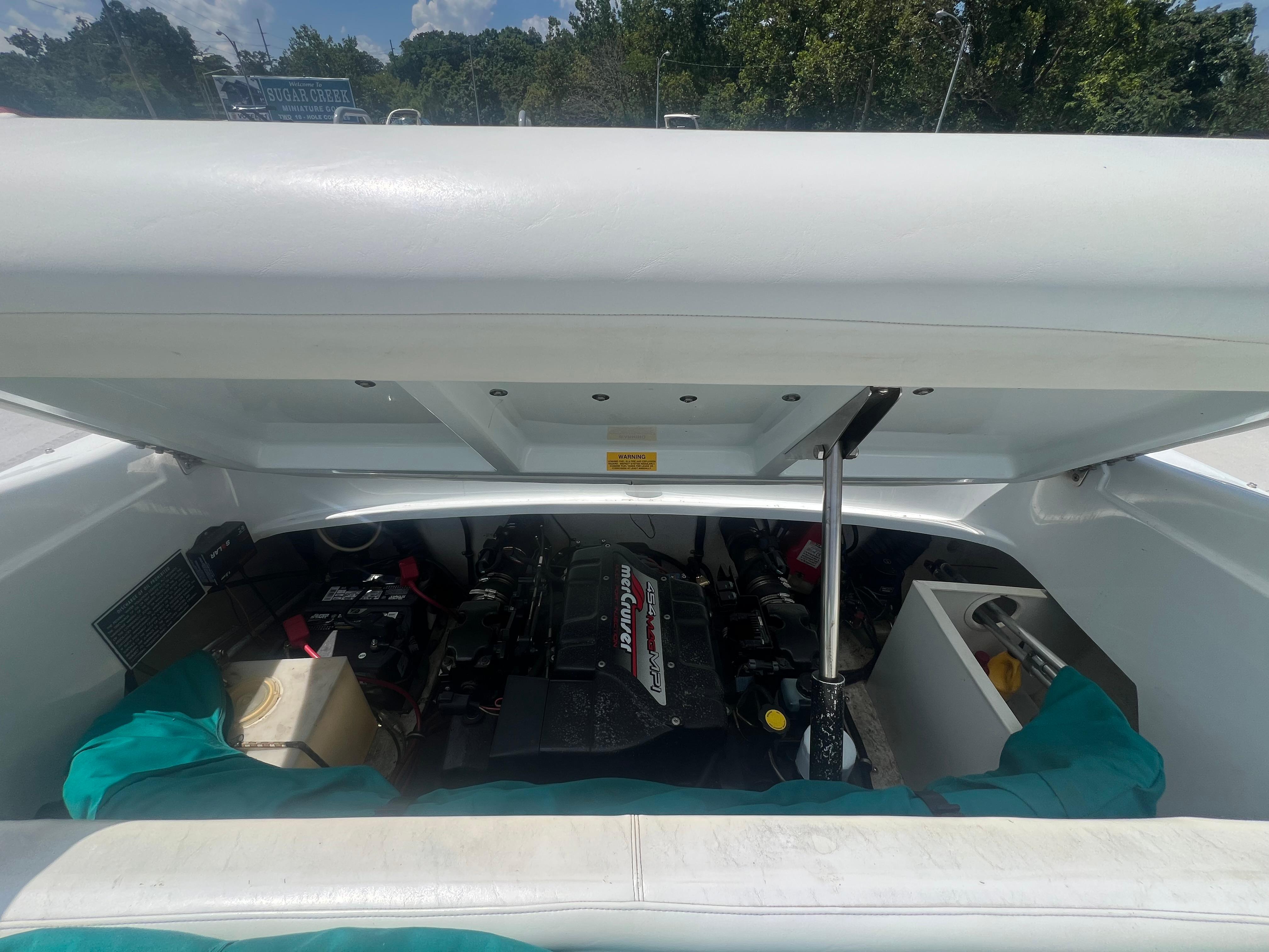 Slide: The Image of 1999 Baja 272 Islander boat engine compartment with MerCruiser engine visible. - 16