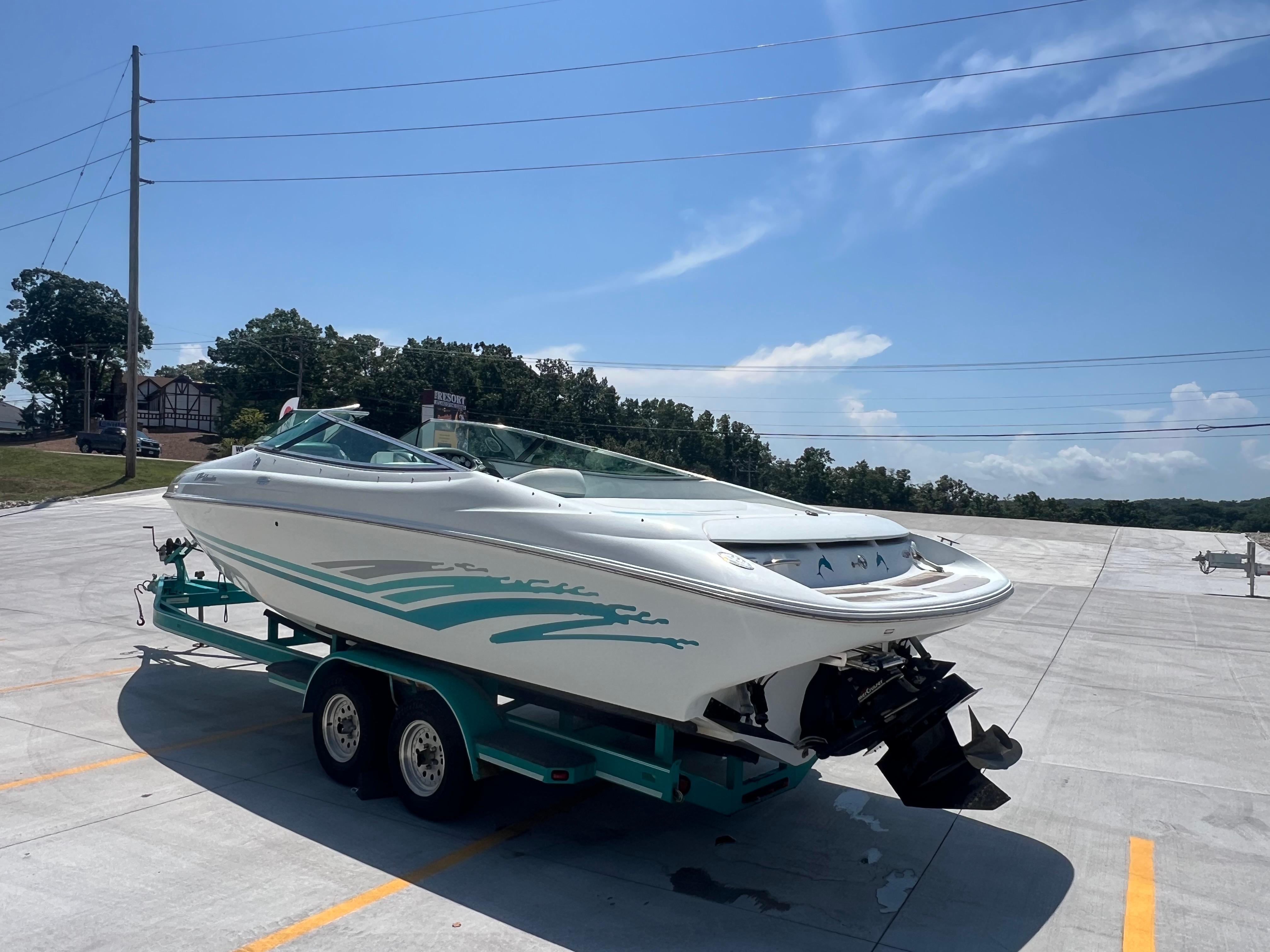 Slide: The Image of 1999 Baja 272 Islander boat on trailer in sunny parking lot. - 3