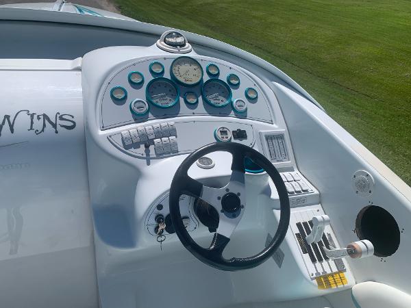 Slide: The Image of 1999 Baja 29 Outlaw SST boat dashboard with steering wheel and gauges. - 12