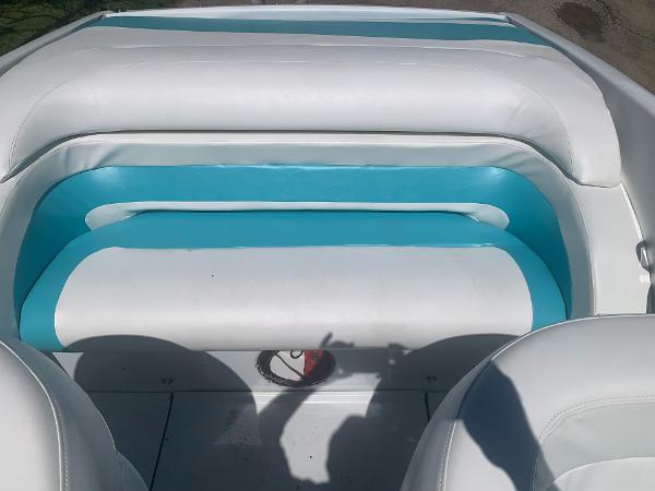 Slide: The Image of 1999 Baja 29 Outlaw SST boat interior with white and teal seating. - 16