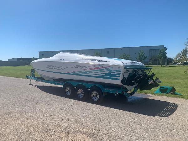 Slide: The Image of 1999 Baja 29 Outlaw SST speedboat on a trailer in a sunny outdoor setting. - 6