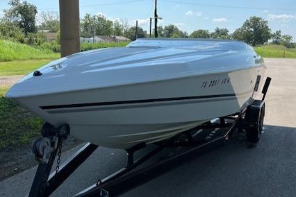 Slide: The Image of 2000 Baja H2X speedboat on trailer, parked outdoors on a sunny day. - 2