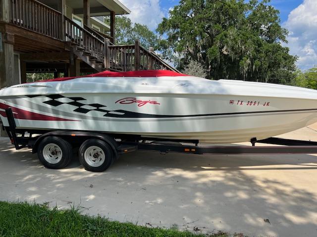 Slide: The Image of 2000 Baja H2X speedboat on trailer, parked outdoors near wooden stairs. - 3