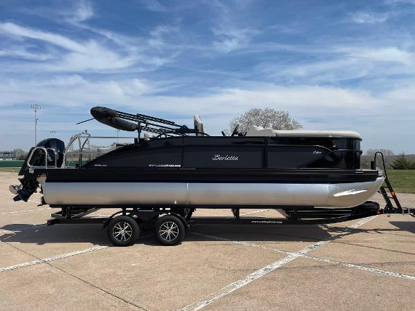 Slide: The Image of 2024 Barletta Cabrio 22UC pontoon boat on a trailer under a clear sky. - 12