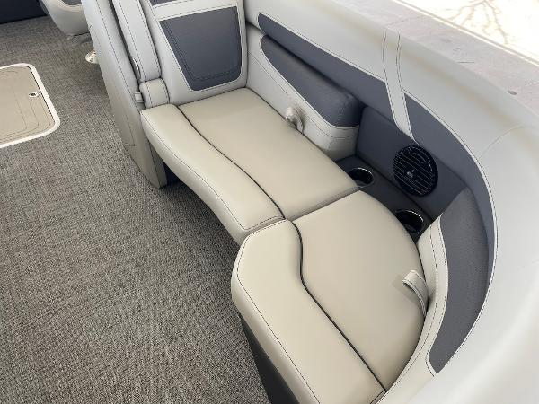 Slide: The Image of 2024 Barletta Cabrio 22UC boat interior seating with cup holders and speaker. - 34