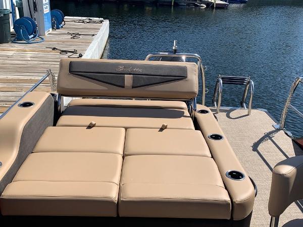 Slide: The Image of 2023 Barletta Cabrio 24UE pontoon boat with tan seating at dock. - 3