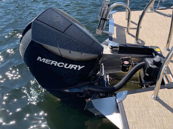 Slide: The Image of 2023 Barletta Cabrio 24UE with Mercury outboard engine on water. - 9