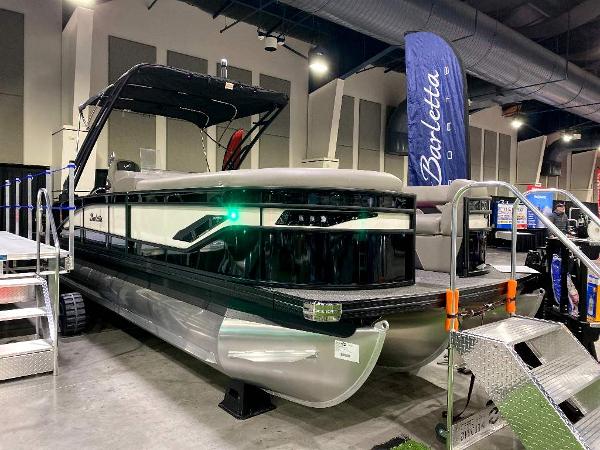 Slide: The Image of 2024 Barletta Corsa Ultra-Lounge 25UCA pontoon boat on display indoors. - 1