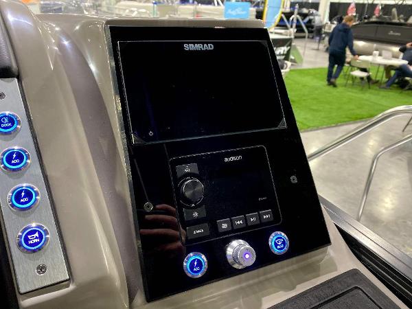 Slide: The Image of 2024 Barletta Corsa Ultra-Lounge 25UCA dashboard with Simrad display and control buttons. - 21