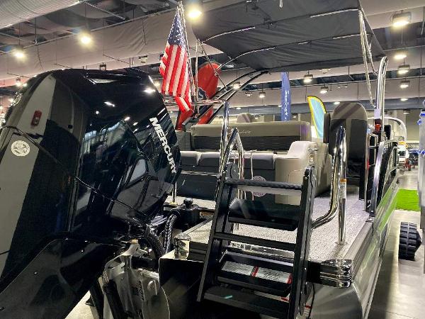 Slide: The Image of 2024 Barletta Corsa Ultra-Lounge 25UCA pontoon boat with Mercury engine at indoor showroom. - 4