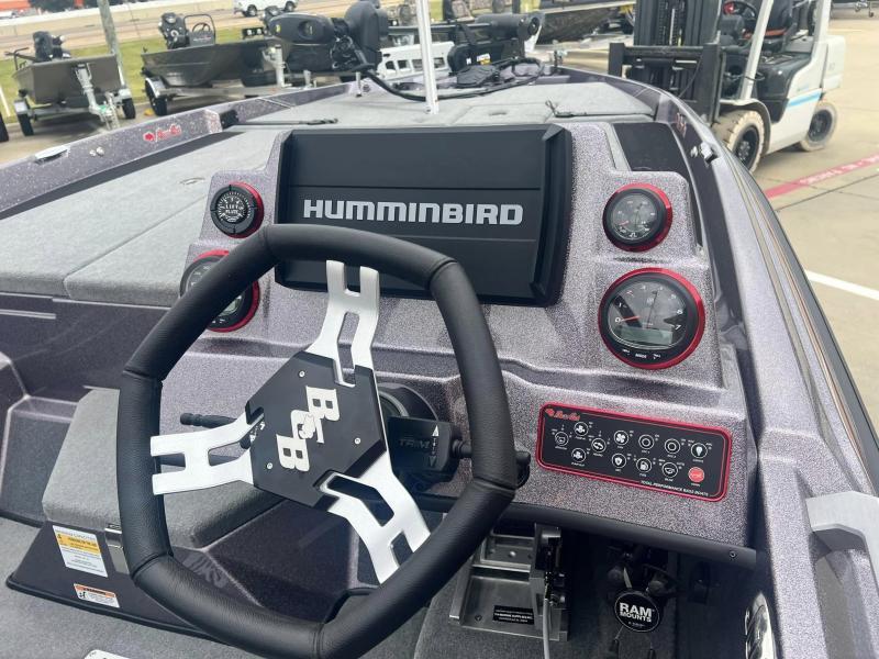 Slide: The Image of 2024 Bass Cat Caracal STS boat dashboard with Humminbird display and B&B steering wheel. - 11