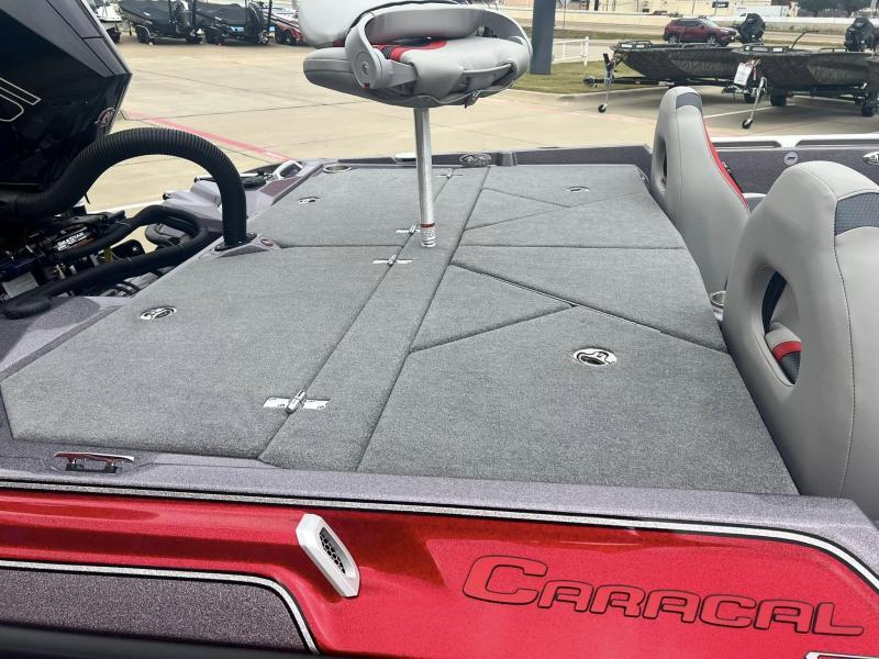 Slide: The Image of 2024 Bass Cat Caracal STS boat interior with gray seating and storage compartments. - 14