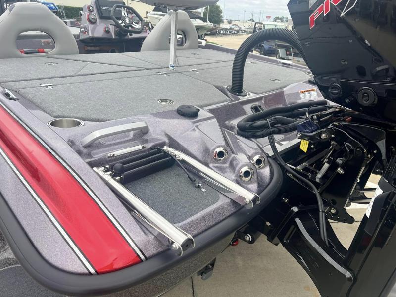 Slide: The Image of 2024 Bass Cat Caracal STS boat rear deck and engine area with ladder and storage compartments. - 19