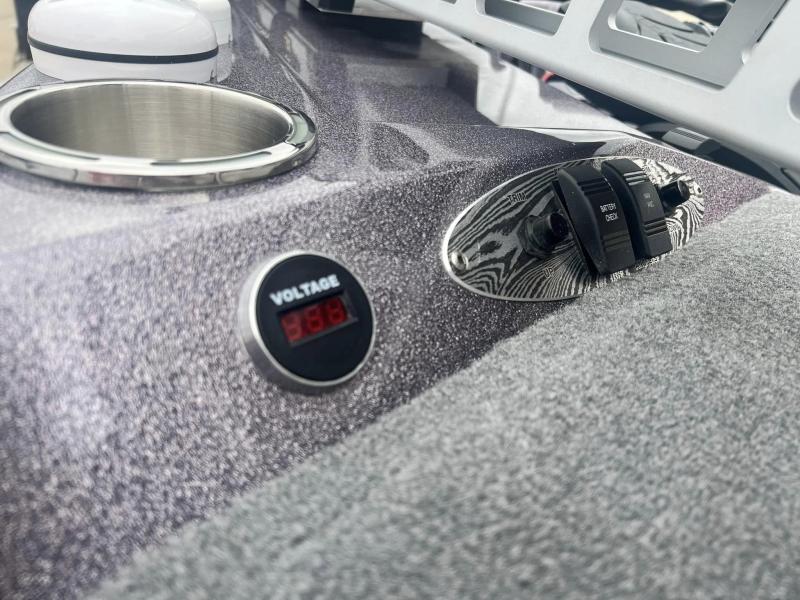Slide: The Image of 2024 Bass Cat Caracal STS dashboard with voltage meter and control switches. - 23