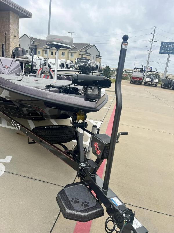 Slide: The Image of 2024 Bass Cat Caracal STS boat on a trailer in a parking lot. - 7
