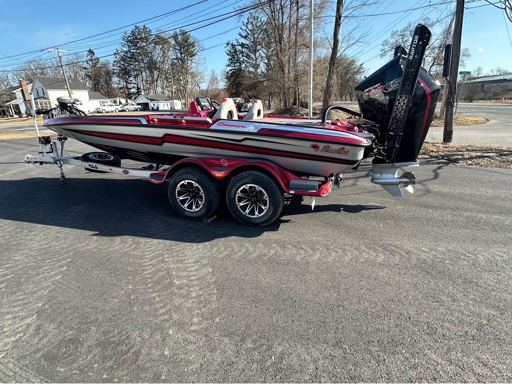 Slide: The Image of 2024 Bass Cat Boats Caracal STS on a trailer, parked on a paved road. - 12