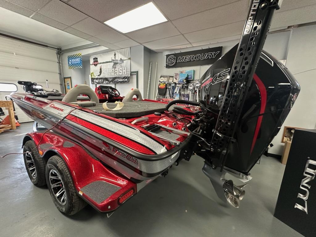 Slide: The Image of 2024 Bass Cat Boats Caracal STS in showroom, featuring sleek design and powerful engine. - 14