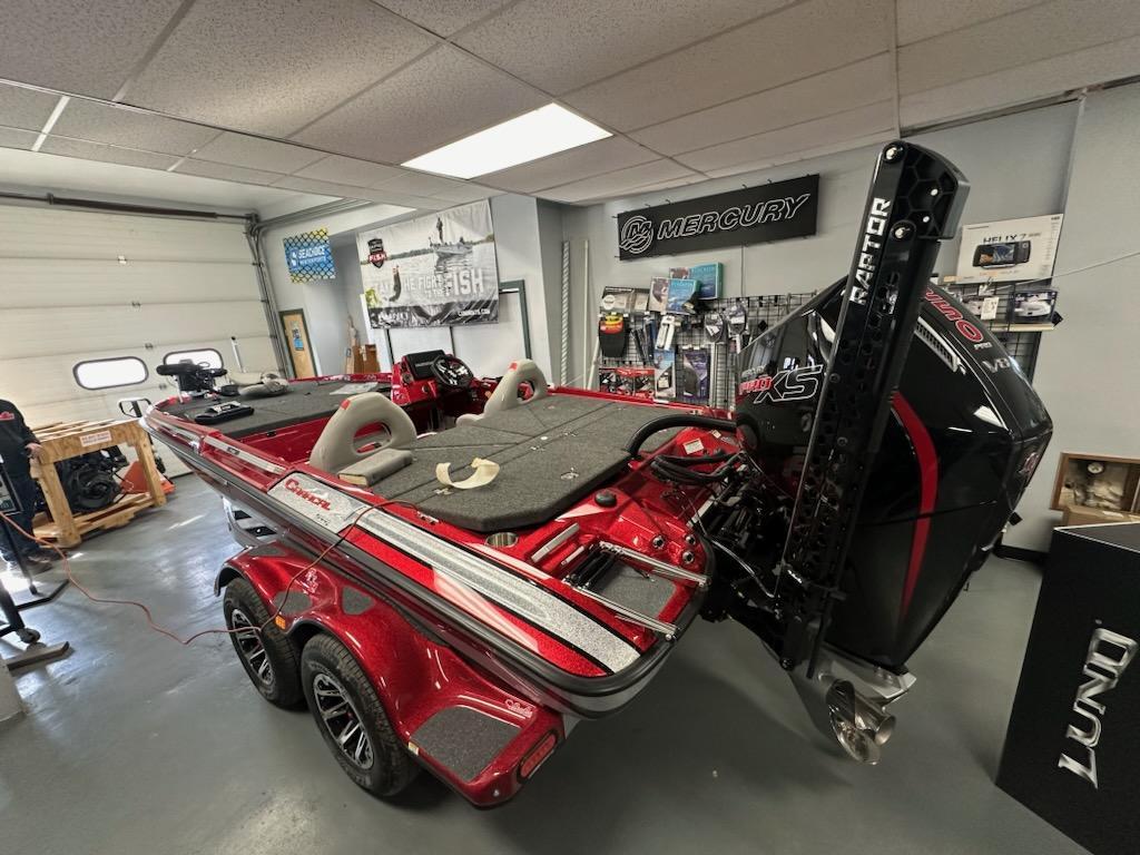 Slide: The Image of 2024 Bass Cat Boats Caracal STS in showroom, featuring sleek design and powerful engine. - 15