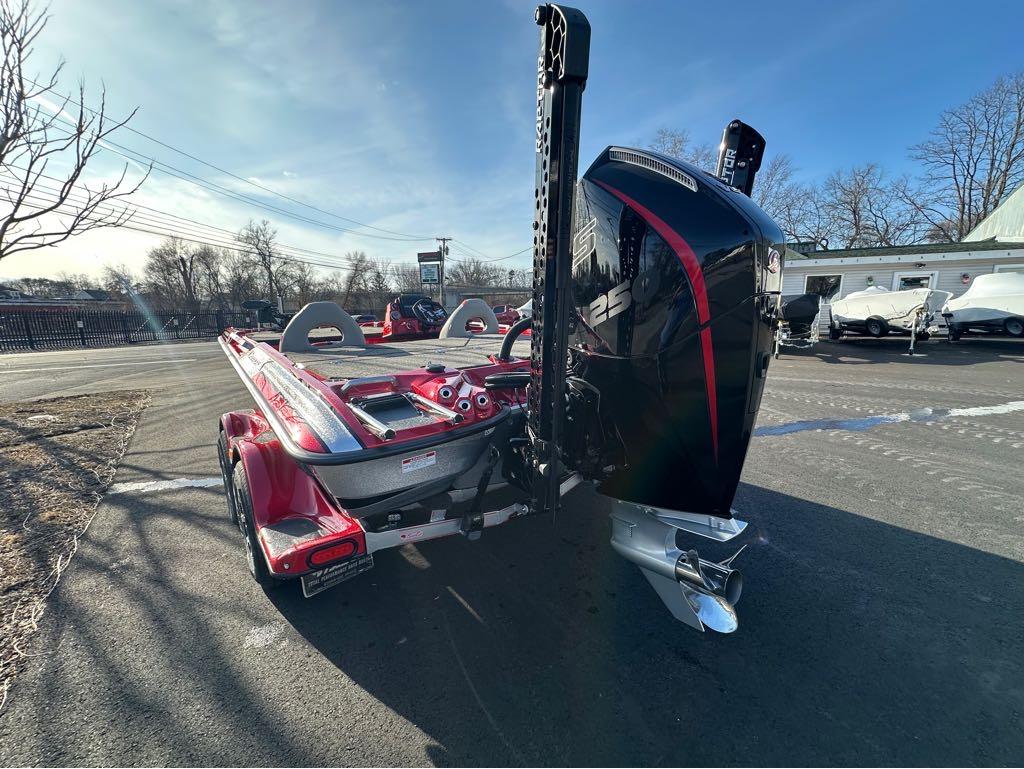 Slide: The Image of 2024 Bass Cat Boats Caracal STS, red, rear view with powerful outboard motor. - 5