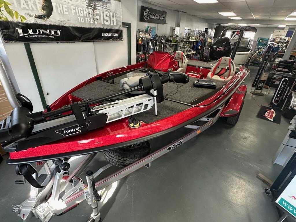 Slide: The Image of 2024 Bass Cat Boats Caracal STS in showroom, featuring red exterior and advanced fishing equipment. - 6