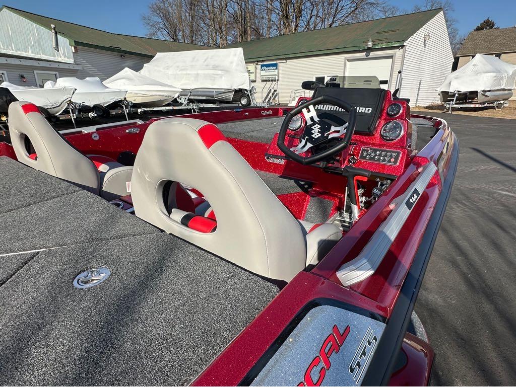 Slide: The Image of 2024 Bass Cat Boats Caracal STS interior with steering console and seats. - 7