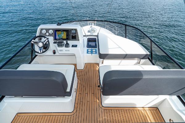 Slide: The Image of Flybridge of 2025 Bavaria Virtess 420 Fly yacht with modern controls and seating. - 25