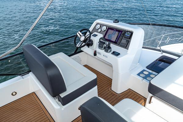 Slide: The Image of 2025 Bavaria Virtess 420 Fly yacht helm with modern navigation system on open water. - 26