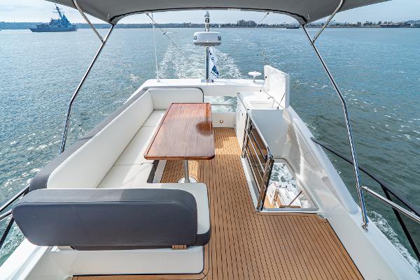 Slide: The Image of Luxurious Bavaria Virtess 420 Fly yacht deck with seating and table, cruising on open water. - 28