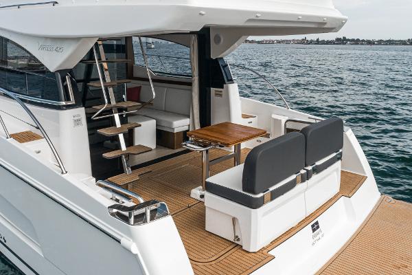 Slide: The Image of 2025 Bavaria Virtess 420 Fly yacht, elegant deck with seating and table, ocean backdrop. - 32
