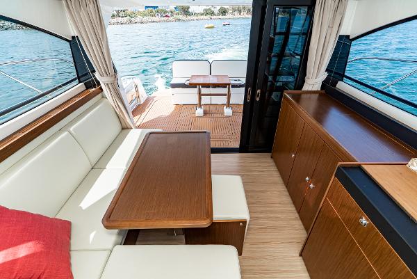 Slide: The Image of Interior of 2025 Bavaria Virtess 420 Fly yacht with elegant seating and wooden table. - 46