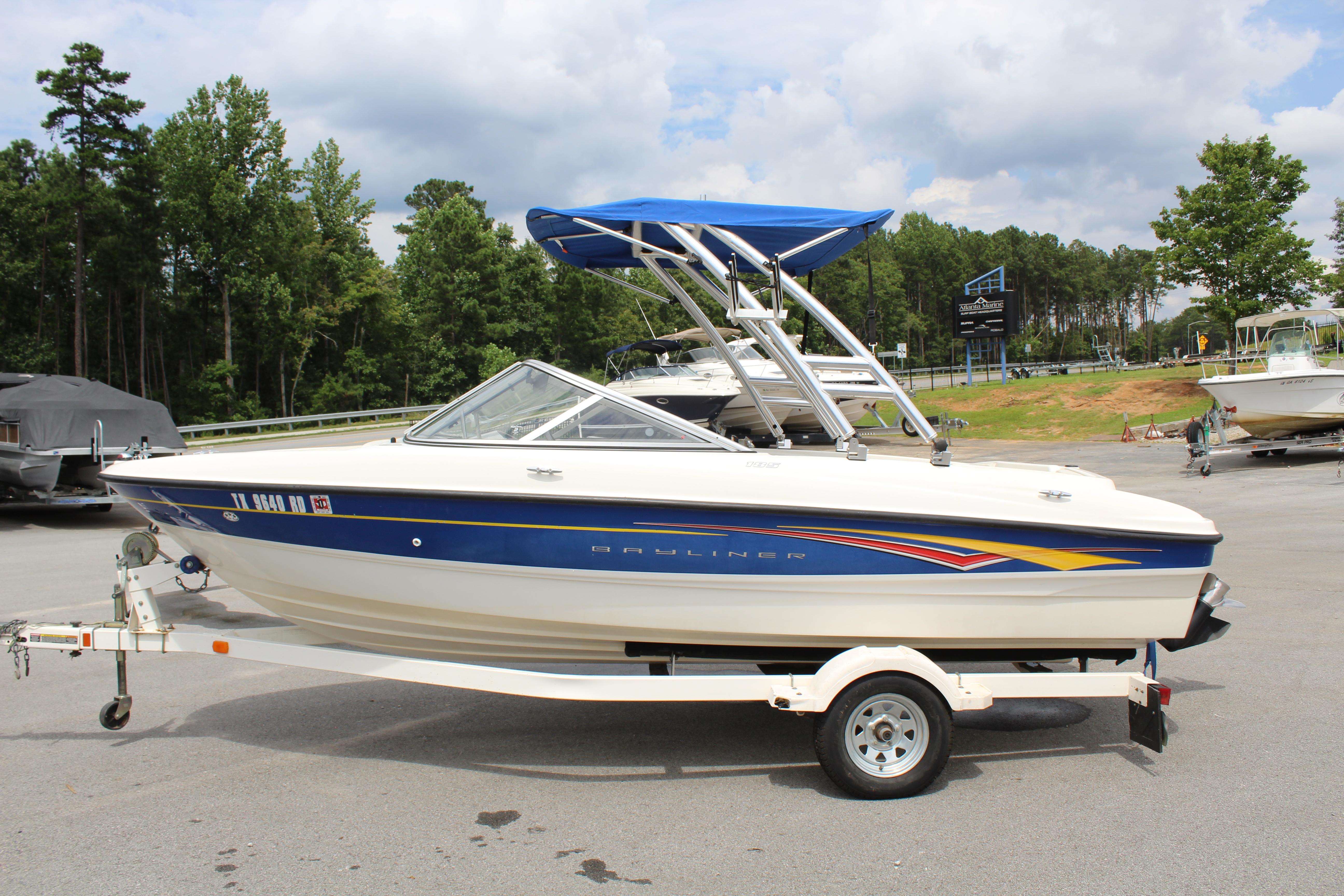 Slide: The Image of 2007 Bayliner 185 Bowrider boat with blue accents on a trailer. - 1