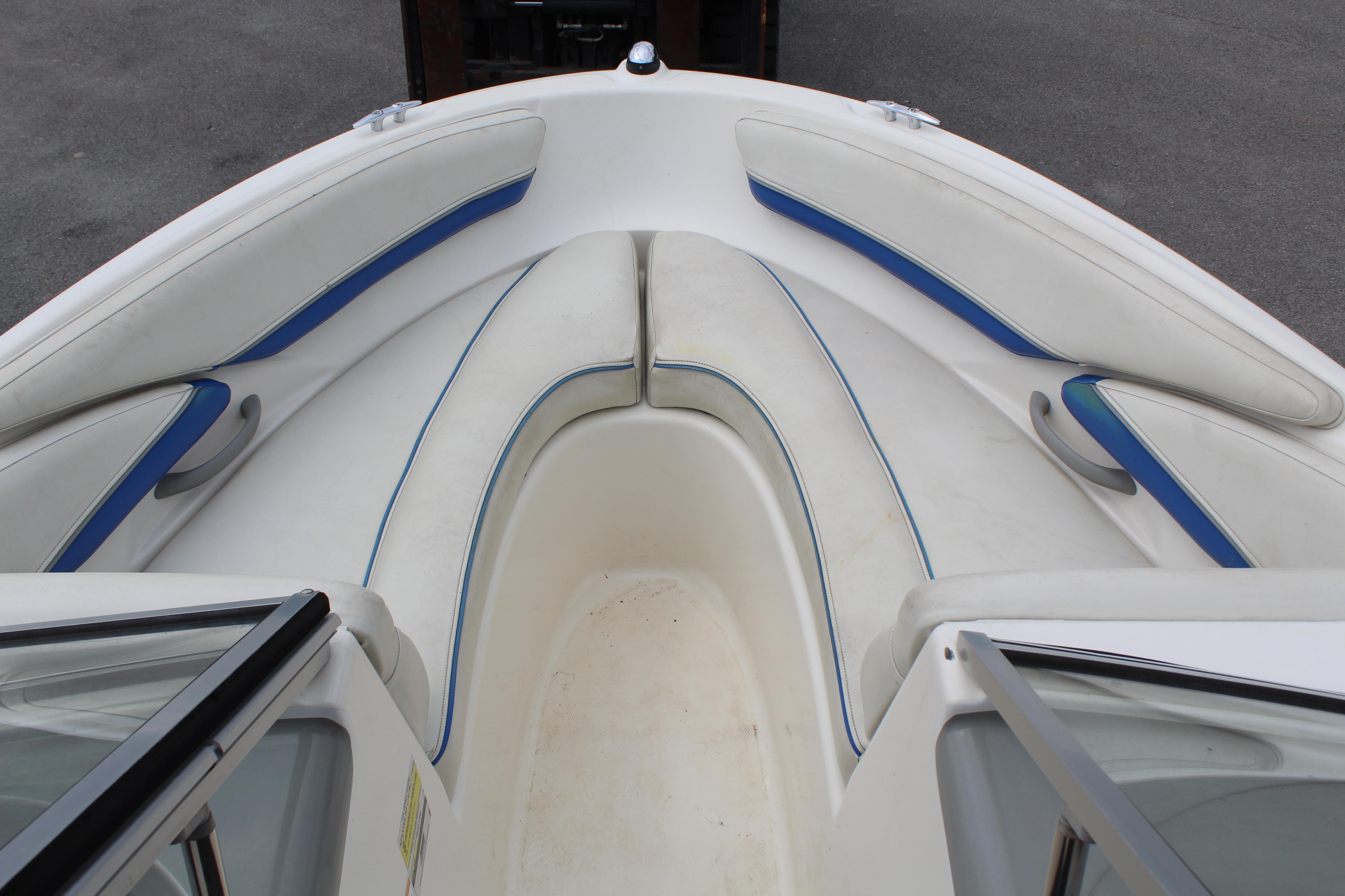 Slide: The Image of 2007 Bayliner 185 Bowrider boat interior with white and blue seating. - 11