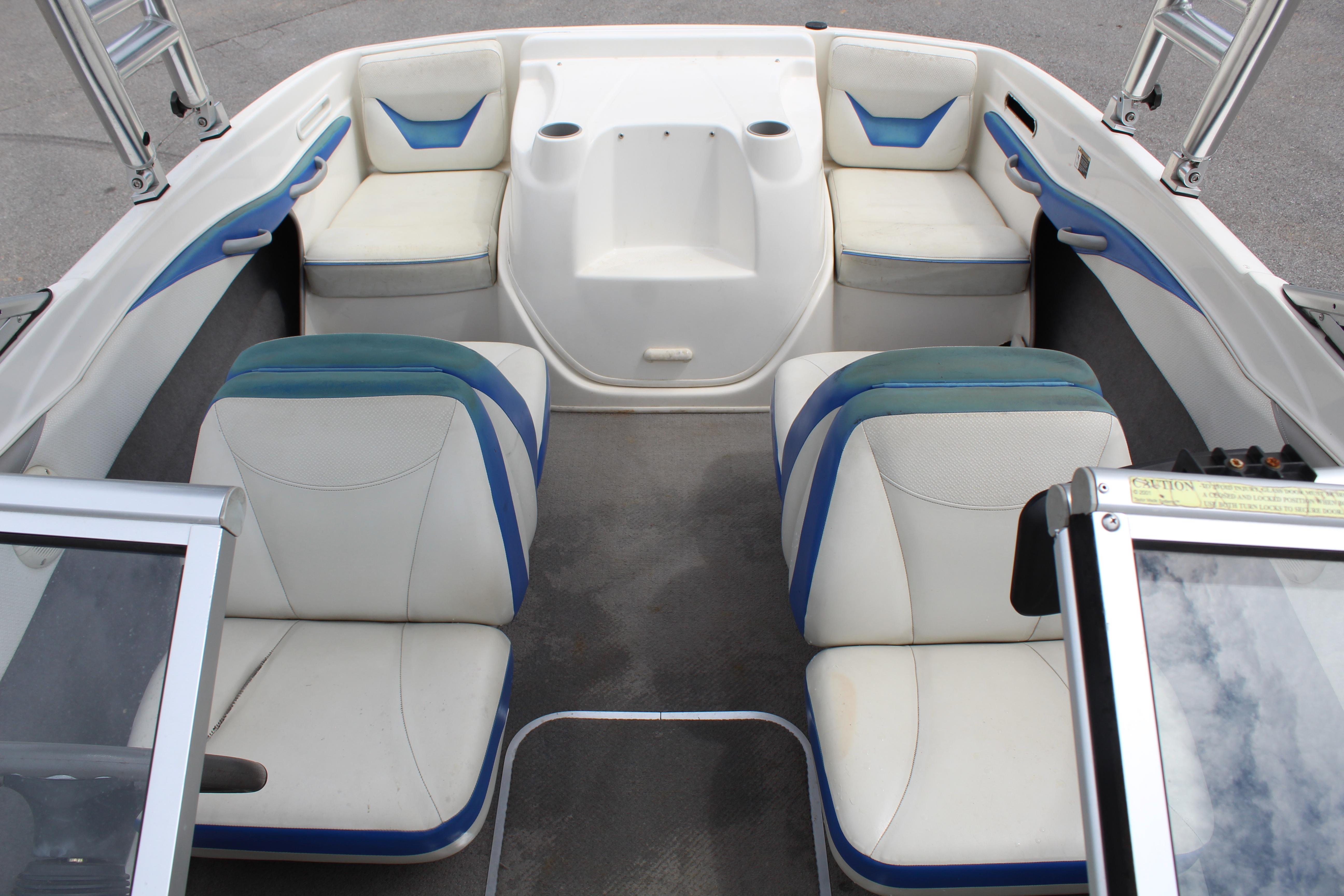 Slide: The Image of 2007 Bayliner 185 Bowrider interior with white and blue seating arrangement. - 13