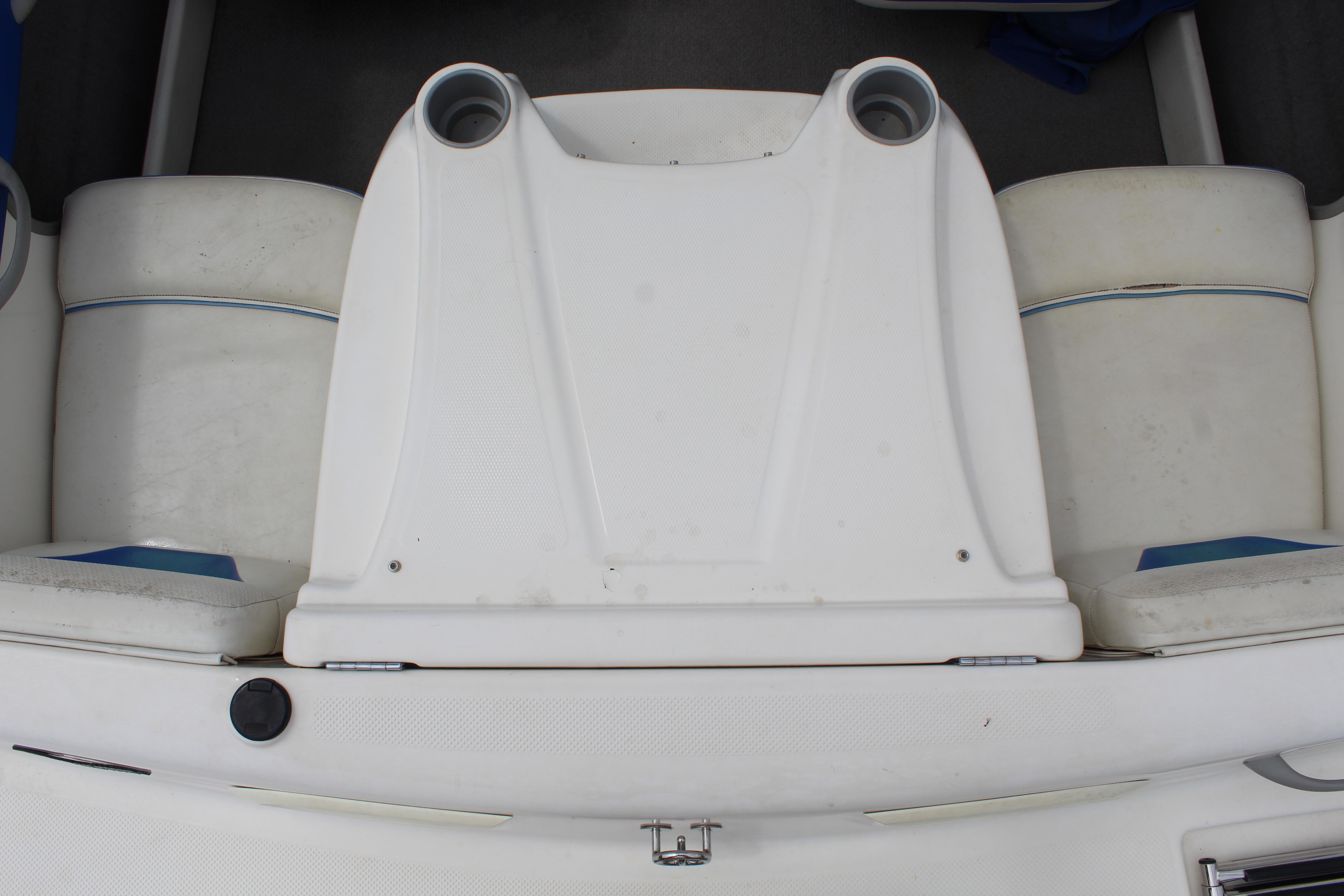 Slide: The Image of 2007 Bayliner 185 Bowrider boat interior with white seating and cup holders. - 14