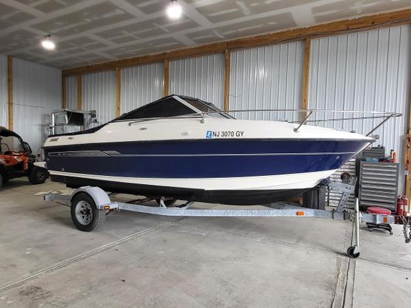 Slide: The Image of 2006 Bayliner 192 Discovery boat on trailer in a garage setting. - 0