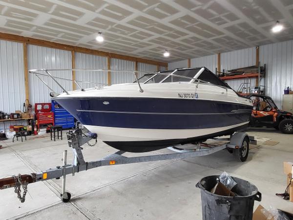Slide: The Image of 2006 Bayliner 192 Discovery boat on trailer in a spacious garage. - 1