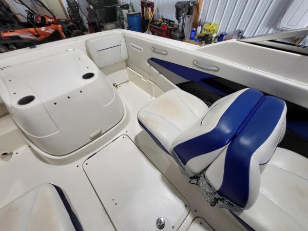 Slide: The Image of 2006 Bayliner 192 Discovery boat interior with blue and white seating. - 11