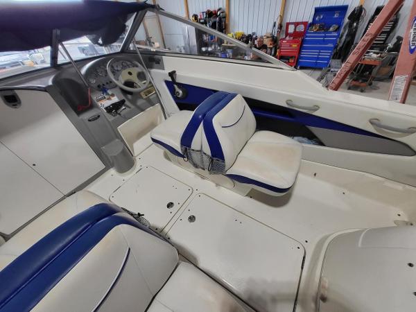 Slide: The Image of Interior of 2006 Bayliner 192 Discovery boat with blue and white seating. - 13