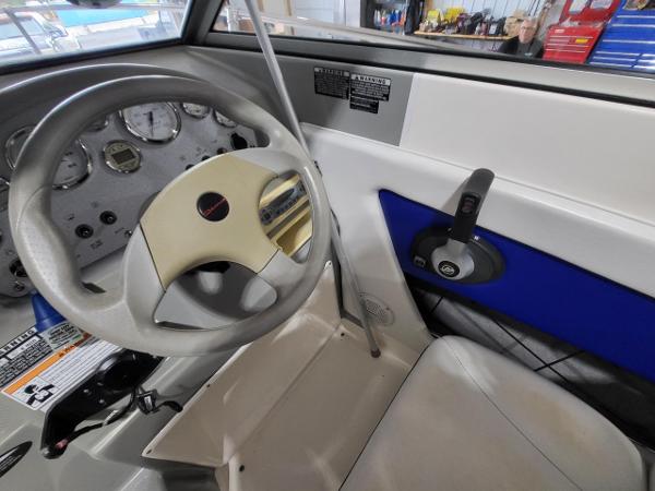 Slide: The Image of 2006 Bayliner 192 Discovery boat cockpit with steering wheel and control panel. - 14