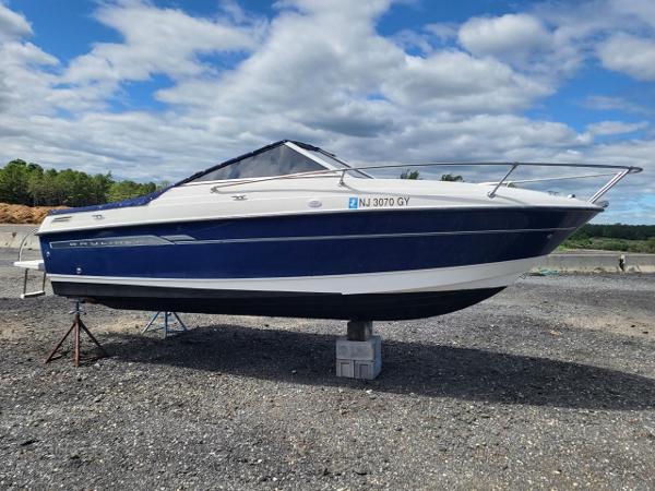 Slide: The Image of 2006 Bayliner 192 Discovery boat on dry land under a cloudy sky. - 17